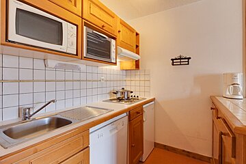 A small kitchen with a microwave and a coffee maker