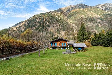 A mountain base advertisement with a house in the background
