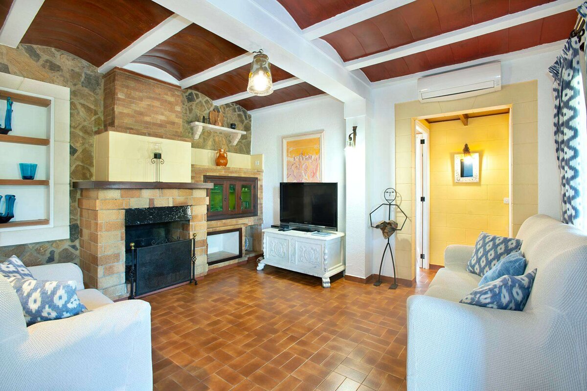 A living room with a fireplace and a flat screen tv