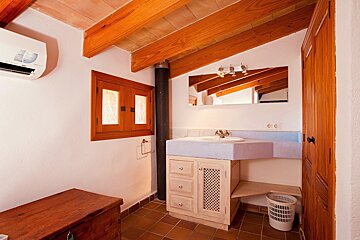 A bathroom with a sink and a white air conditioner