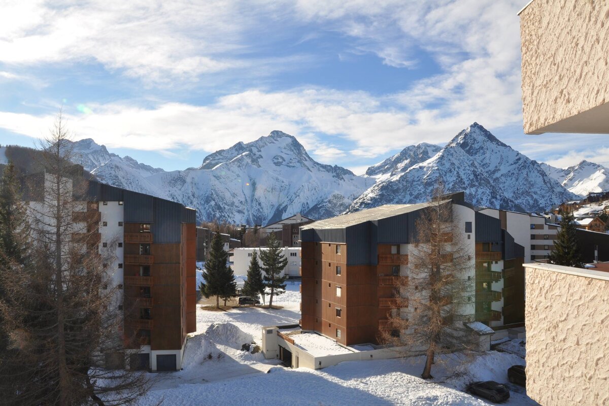 A snowy mountain behind a row of buildings