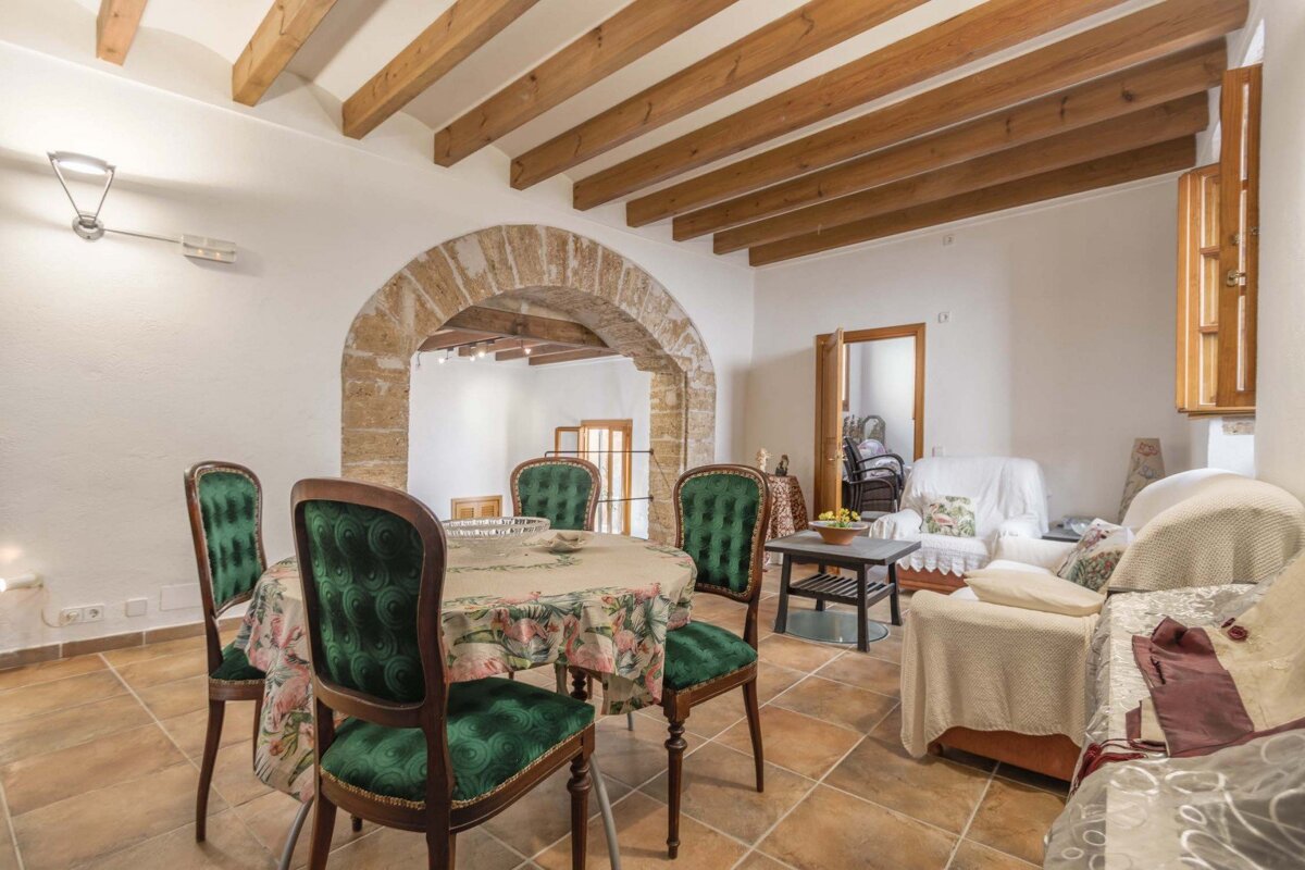 A living room with a table and chairs and a couch