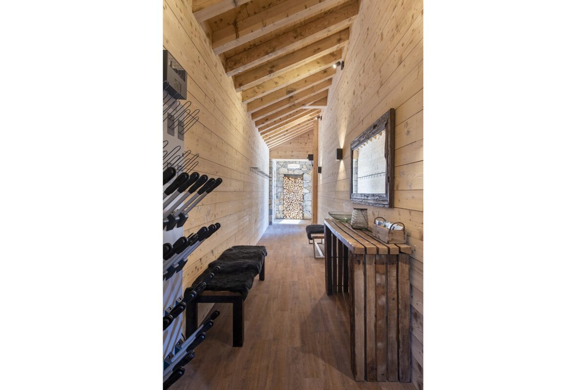 A long hallway with a wooden table and a mirror
