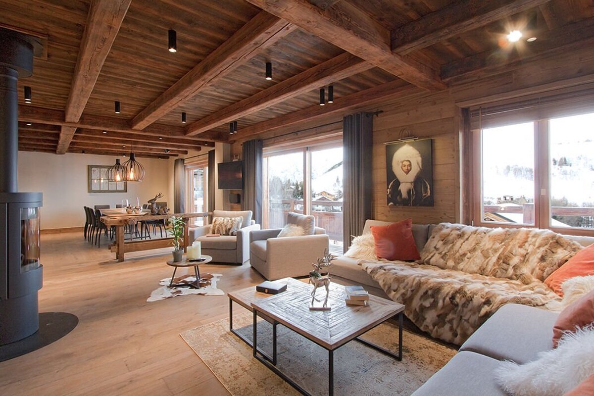 A living room with a couch and chairs and a fireplace
