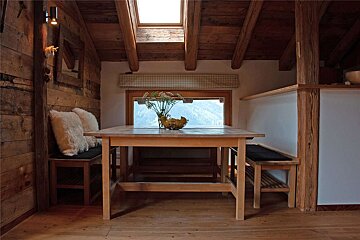 A wooden table with a vase of flowers on it