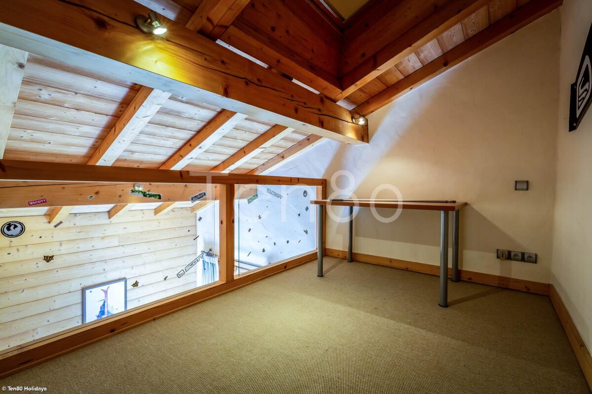 A room with a wooden ceiling and a desk with the word holidays on it