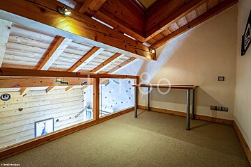 A room with a wooden ceiling and a desk with the word holidays on it