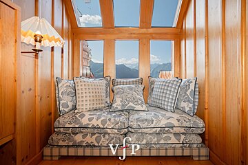A couch with blue and white pillows and a vjp logo