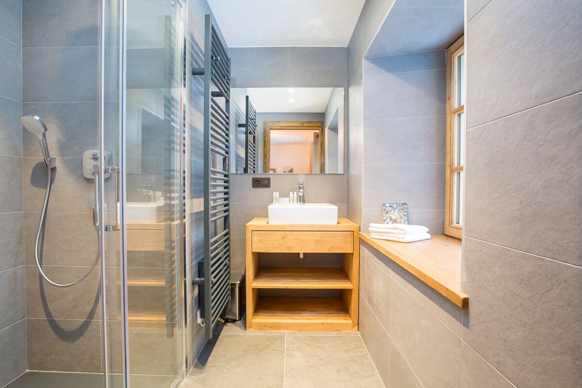 A bathroom with a sink and a walk in shower