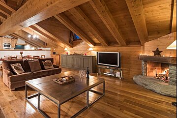 A living room with a fireplace and a flat screen tv
