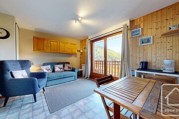 A living room with a couch a chair a table and a coffee maker