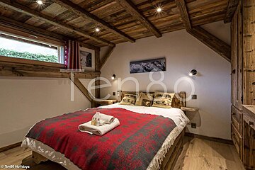 A bedroom with a bed and a picture on the wall that says ten80 holidays