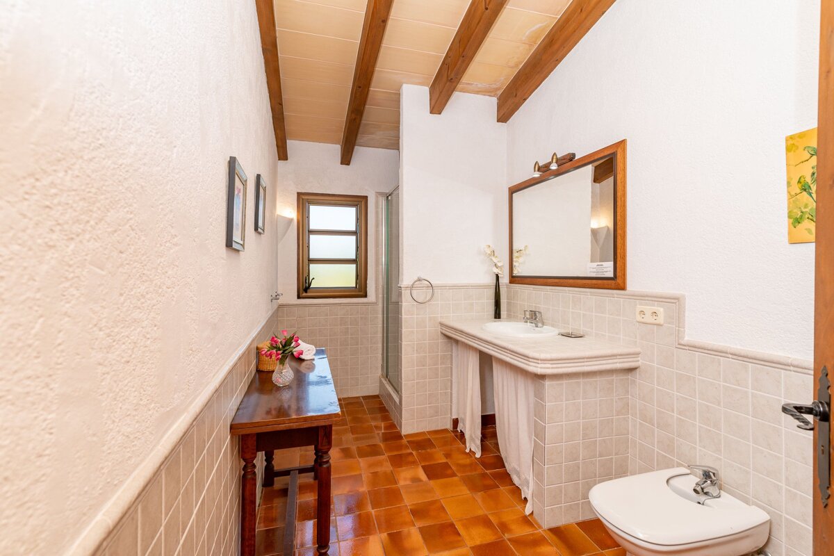 A bathroom with a sink toilet and mirror