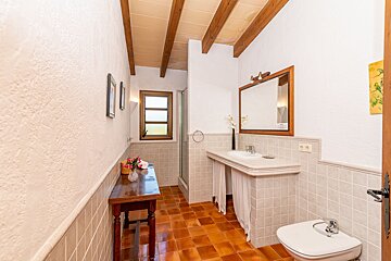 A bathroom with a sink toilet and mirror