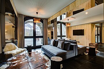 A living room with a couch a chair and a television