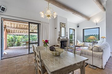 A dining room table with a bowl of lavender on it