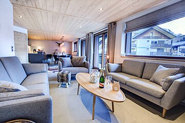 A bottle of champagne sits on a table in a living room