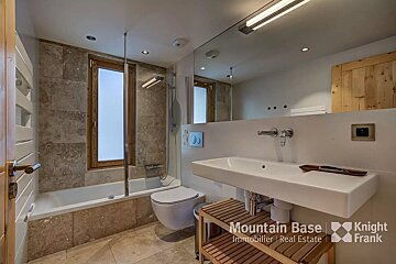 A bathroom with a knight frank logo on the wall
