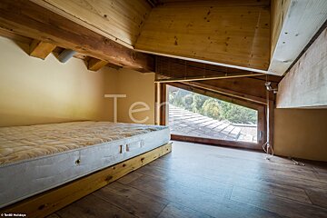 A bedroom with a mattress and a window with the word ter on it