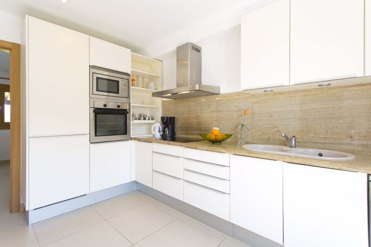 A living room with two couches and two paintings on the wall