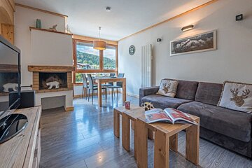 A living room with a couch a table and a fireplace with the number 12 on the wall