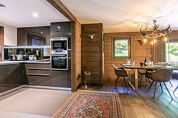 A kitchen and dining area with a rug on the floor