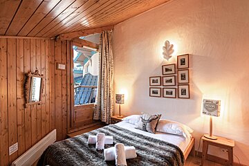 A bedroom with a bed and a lamp with a heart on it
