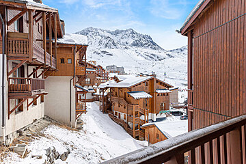 A view of a ski resort with mountains in the background