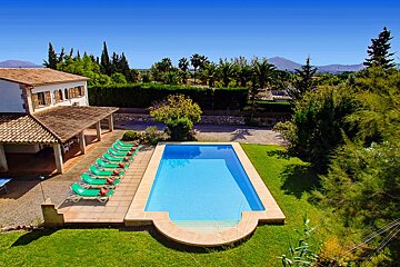 A large swimming pool in front of a house