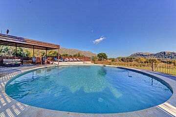 A large swimming pool with mountains in the background