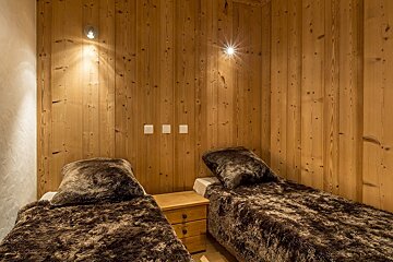 A kitchen with wooden cabinets and a black counter top