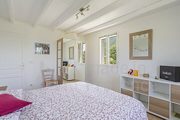 A bedroom with a bed and a box that says ba&sh on it