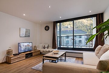 A living room with a couch and a flat screen tv