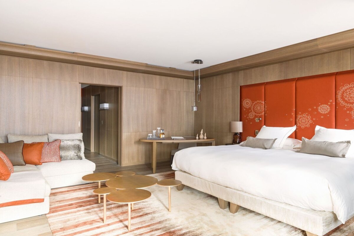 A hotel room with a large bed and a couch