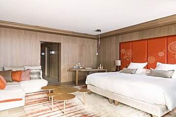 A hotel room with a large bed and a couch