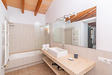 A bathroom with a sink and a large mirror
