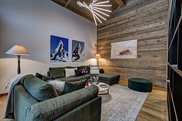 A living room with a couch and two paintings on the wall