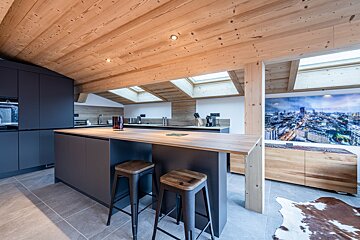 A kitchen with a picture of a city on the wall