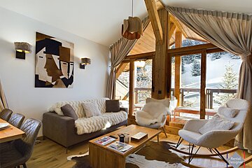 A bed in a bedroom with trees on the wall