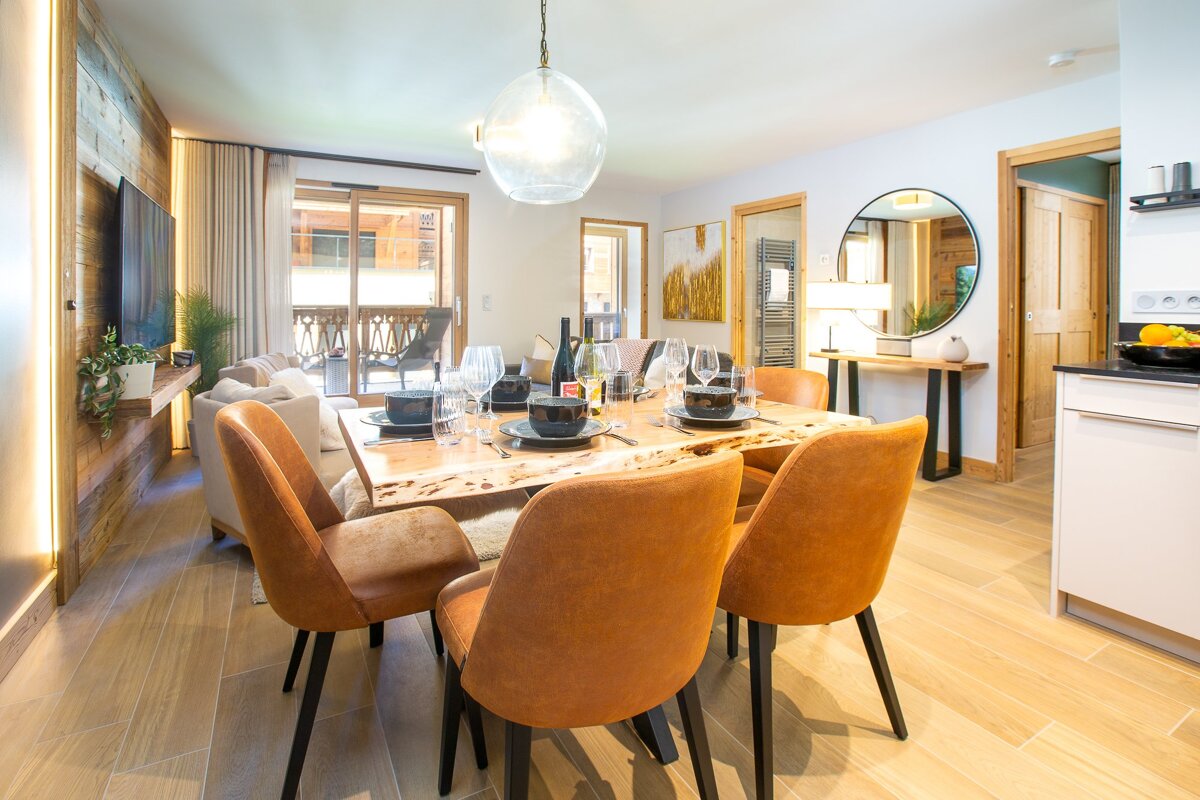 A living room with a dining table and chairs