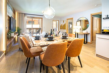 A living room with a dining table and chairs