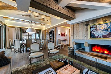 A living room with a fireplace and a painting on the wall