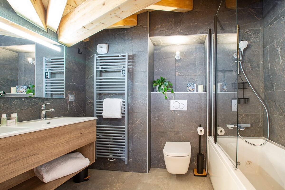 A bathroom with a toilet a sink and a shower