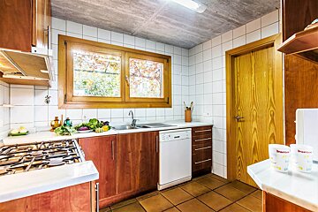 A kitchen with a stove top oven and a dishwasher