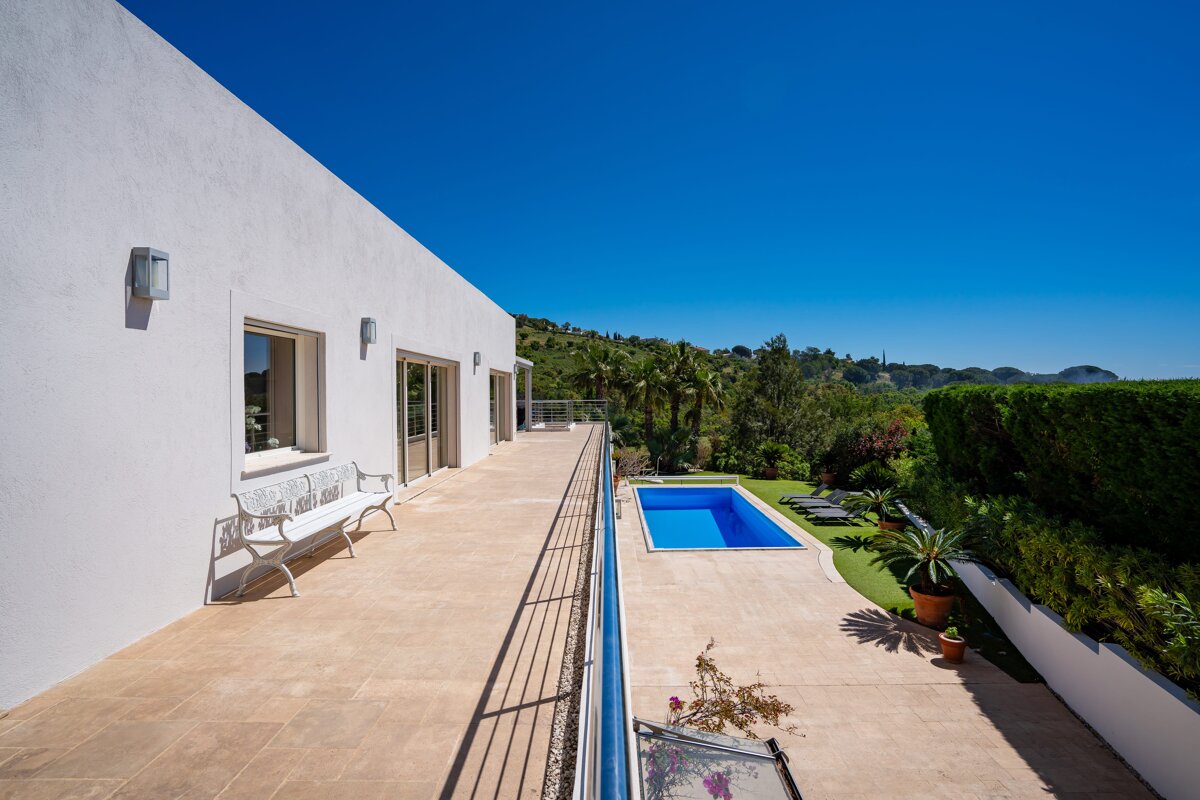 A large white house with a swimming pool in the backyard