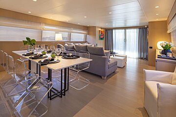 A living room with a dining table and chairs