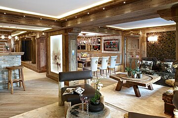 A living room with a wooden table and chairs