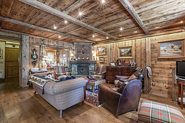 A living room with a couch and chairs and a fireplace