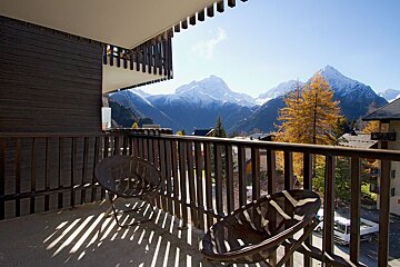 A balcony with a view of a mountain range
