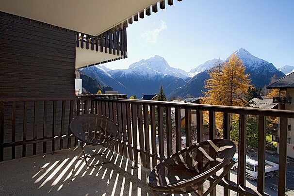 A balcony with a view of a mountain range